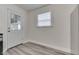 Entryway featuring a white door with glass panes and gray vinyl plank flooring at 2245 N Ritter Ave, Indianapolis, IN 46218