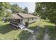 Quaint home featuring a screened-in porch, cream siding and a detached garage at 2245 N Ritter Ave, Indianapolis, IN 46218