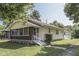 Quaint home featuring a screened-in porch, cream siding and a detached garage at 2245 N Ritter Ave, Indianapolis, IN 46218