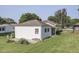 Back corner of a house with a detached garage and brick accents and green lawn at 2245 N Ritter Ave, Indianapolis, IN 46218