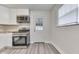 Kitchen featuring stainless steel appliances, white cabinets, and a door with glass panes at 2245 N Ritter Ave, Indianapolis, IN 46218