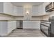 Bright kitchen featuring new stainless appliances, light countertops, and shaker cabinets at 2245 N Ritter Ave, Indianapolis, IN 46218