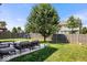 A backyard with a patio set, a large tree, a fence and a playset at 2426 Autumn Rd, Indianapolis, IN 46229