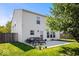 A backyard with a patio set, grass, potted plants and a house at 2426 Autumn Rd, Indianapolis, IN 46229