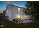 A backyard with a patio set, grass, potted plants and a house during the evening at 2426 Autumn Rd, Indianapolis, IN 46229