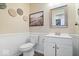 Charming powder room features white wainscoting, a modern vanity, and stylish decorations at 2426 Autumn Rd, Indianapolis, IN 46229