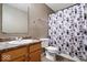 Bathroom featuring wood vanity, floral shower curtain, toilet, and speckled countertop at 2426 Autumn Rd, Indianapolis, IN 46229