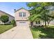 Charming two-story brick home with a well-maintained lawn and attached two-car garage at 2426 Autumn Rd, Indianapolis, IN 46229