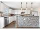 Well-lit kitchen boasts white cabinets, stainless steel appliances, and a decorative backsplash at 2426 Autumn Rd, Indianapolis, IN 46229