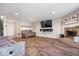 Spacious living room features a brick fireplace, modern wood flooring, and lots of natural light at 2426 Autumn Rd, Indianapolis, IN 46229