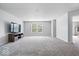 Expansive living room features plush carpeting, neutral tones, and large windows at 2426 Autumn Rd, Indianapolis, IN 46229
