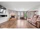 Spacious living room features a brick fireplace, modern wood flooring, and lots of natural light at 2426 Autumn Rd, Indianapolis, IN 46229