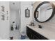 Bathroom featuring updated vanity with round mirror and a walk-in shower at 2717 Reflection Way, Greenwood, IN 46143