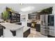 Modern kitchen with stainless steel appliances, stylish dark cabinets, and quartz countertops at 2717 Reflection Way, Greenwood, IN 46143