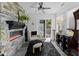 Cozy sunroom featuring a stone fireplace, plush seating, and ample natural light at 2717 Reflection Way, Greenwood, IN 46143
