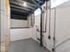 Unfinished basement area with exposed pipes, window, and framed wall sections at 2719 Denison St, Indianapolis, IN 46241