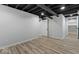 Finished basement space features painted ceiling, laminate flooring, and a storage area at 2719 Denison St, Indianapolis, IN 46241