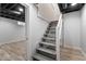 Basement stairs lead to a finished room with plank flooring and a painted ceiling at 2719 Denison St, Indianapolis, IN 46241