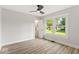 Well-lit bedroom showcasing two windows, a ceiling fan, and wood flooring at 2719 Denison St, Indianapolis, IN 46241