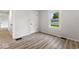 This bedroom has wood floors, a window, and an interior door at 2719 Denison St, Indianapolis, IN 46241
