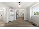 Open floor plan: dining room leading to a modern kitchen featuring stainless steel appliances and hardwood floors at 2719 Denison St, Indianapolis, IN 46241
