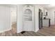 Dining room leading to a modern kitchen featuring stainless steel appliances and hardwood floors at 2719 Denison St, Indianapolis, IN 46241