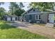 The exterior features a long driveway, green lawn, and an oversized garage at 2719 Denison St, Indianapolis, IN 46241
