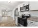 The open concept kitchen features modern appliances, granite countertops, and plenty of storage space at 2719 Denison St, Indianapolis, IN 46241