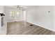 Bright living room with a white-painted brick fireplace, ceiling fan, and hardwood floors at 2719 Denison St, Indianapolis, IN 46241