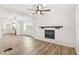 Bright living room with a white-painted brick fireplace, ceiling fan, and hardwood floors at 2719 Denison St, Indianapolis, IN 46241