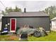 Backyard features a red door, covered items, and a grill at 2954 N Drexel Ave, Indianapolis, IN 46218