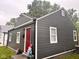 Cozy home with gray siding, white trim, red door, and well-manicured front yard at 2954 N Drexel Ave, Indianapolis, IN 46218