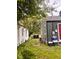 Features a gravel driveway, outdoor equipment, and a view of both the house and garage at 2954 N Drexel Ave, Indianapolis, IN 46218
