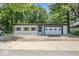 Exterior of home with vinyl siding and garage door nestled amongst mature trees and concrete driveway at 3529 Hunt St, Plainfield, IN 46168