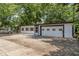 This garage features a large roll-up door and off street parking at 3529 Hunt St, Plainfield, IN 46168