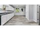 Bright kitchen boasts white cabinets, gray countertops, new appliances, and durable wood-look flooring at 3529 Hunt St, Plainfield, IN 46168