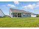 A spacious backyard featuring well-maintained lawn and a covered patio, perfect for relaxing or entertaining at 3839 Albert Ln, Bargersville, IN 46106
