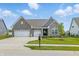 Charming home features a landscaped yard, three car garage and inviting curb appeal at 3839 Albert Ln, Bargersville, IN 46106