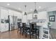 A modern kitchen with stainless steel appliances, a central island, and ample white cabinetry at 3839 Albert Ln, Bargersville, IN 46106