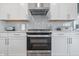 Modern kitchen showcasing white cabinets, a stainless steel oven, and contemporary finishes for a sleek design at 3839 Albert Ln, Bargersville, IN 46106