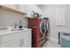 Modern laundry room featuring a sink, counter space, and side-by-side washer and dryer for convenience at 3839 Albert Ln, Bargersville, IN 46106