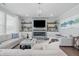 Bright living room with a modern fireplace, mounted TV, floating shelves, and comfortable couches at 3839 Albert Ln, Bargersville, IN 46106
