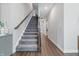 Bright foyer with a carpeted staircase and modern wooden handrail, offering a stylish and functional design at 3839 Albert Ln, Bargersville, IN 46106