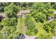 Aerial view showcasing property with mature trees, expansive green lawn, and circular driveway at 450 W 93Rd St, Indianapolis, IN 46260