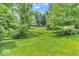 Lush green front yard featuring mature trees and landscaping at 450 W 93Rd St, Indianapolis, IN 46260