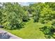 Inviting home surrounded by lush greenery, featuring a spacious lawn perfect for outdoor activities at 450 W 93Rd St, Indianapolis, IN 46260