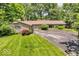 Charming home boasting a well-maintained lawn, circular driveway, and mature landscaping for added privacy at 450 W 93Rd St, Indianapolis, IN 46260