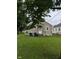View of the back of the house with lawn and trees at 4715 Normal Ave, Indianapolis, IN 46226