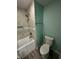 Bathroom featuring neutral tile, a shower and bathtub combo and painted walls at 4715 Normal Ave, Indianapolis, IN 46226