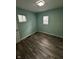 Roomy bedroom with two windows, neutral paint, and wood look flooring at 4715 Normal Ave, Indianapolis, IN 46226